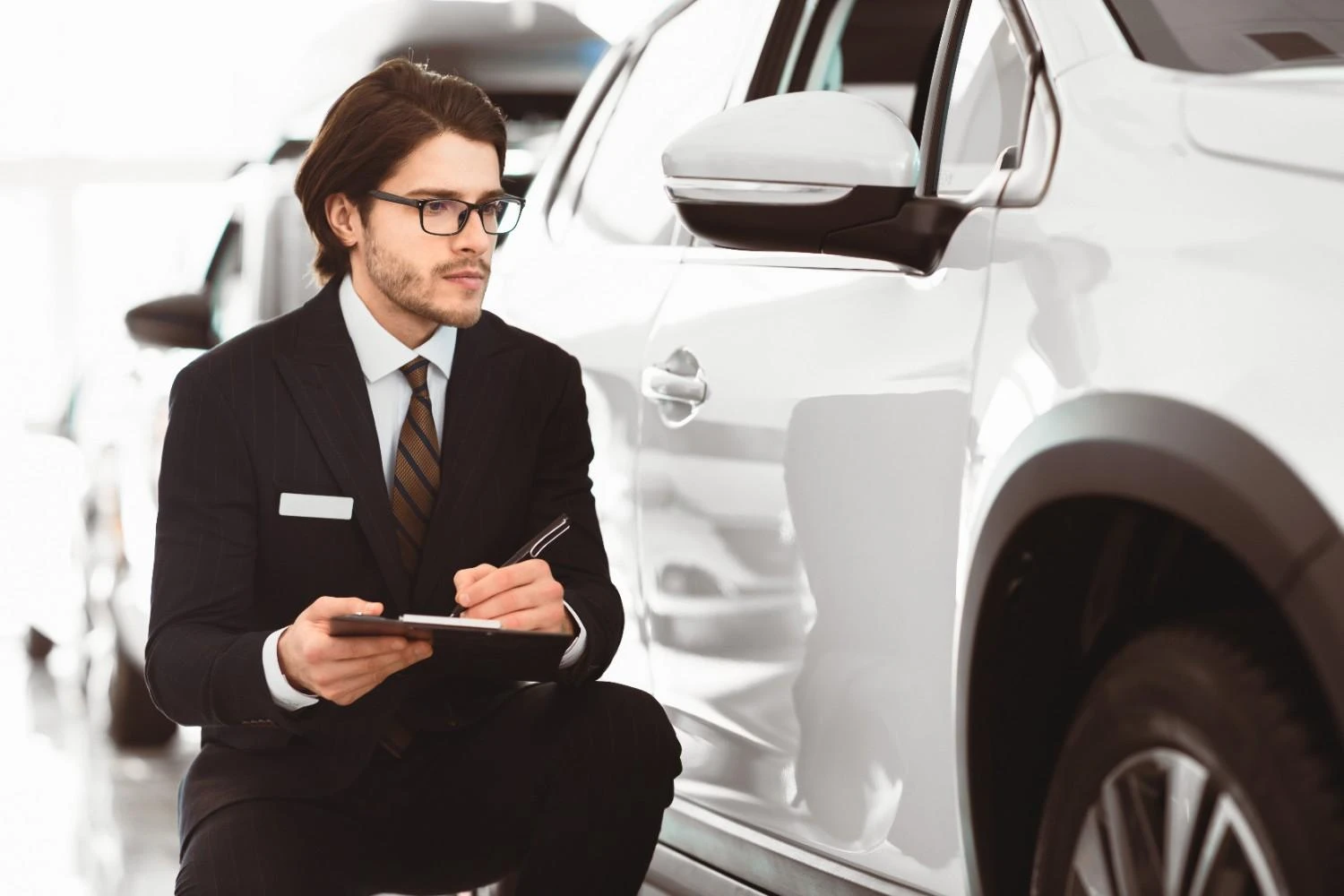 Driver reviewing car insurance options at a dealership
